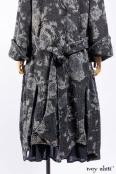Monceau Duster Coat in Mansard Roof Washed Floral Woolen Weave; Lydia Neck Wrap in Slate Washed Linen; Blanchefleur Dress in Mansard Roof Washed Weave; Cilla Slip Frock in Signature Black Ribbed Knit; Porte Cochere Sash in Mansard Roof Washed Floral Woolen Weave.