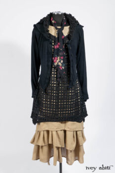 Limited Edition Coulson Cardigan in Signature Black Ribbed Knit; Clotaire Sash in Riverside Floral Silk Chiffon; Bedloe Frock in Mansard Roof Open Woolen Weave; Everett Frock in Uptown Washed Weave.