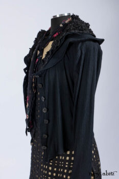 Limited Edition Coulson Cardigan in Signature Black Ribbed Knit; Clotaire Sash in Riverside Floral Silk Chiffon; Bedloe Frock in Mansard Roof Open Woolen Weave; Everett Frock in Uptown Washed Weave.
