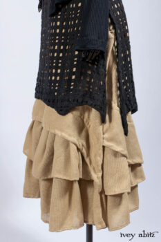 Limited Edition Coulson Cardigan in Signature Black Ribbed Knit; Clotaire Sash in Riverside Floral Silk Chiffon; Bedloe Frock in Mansard Roof Open Woolen Weave; Everett Frock in Uptown Washed Weave.