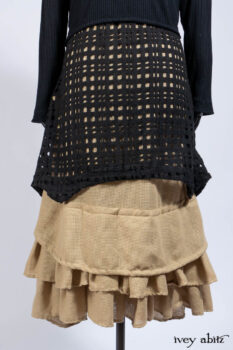 Limited Edition Coulson Cardigan in Signature Black Ribbed Knit; Clotaire Sash in Riverside Floral Silk Chiffon; Bedloe Frock in Mansard Roof Open Woolen Weave; Everett Frock in Uptown Washed Weave.