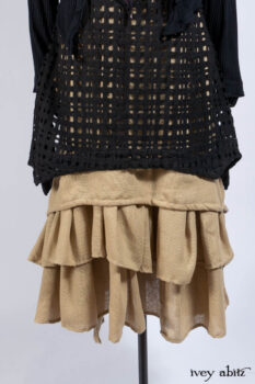 Limited Edition Coulson Cardigan in Signature Black Ribbed Knit; Clotaire Sash in Riverside Floral Silk Chiffon; Bedloe Frock in Mansard Roof Open Woolen Weave; Everett Frock in Uptown Washed Weave.