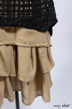 Limited Edition Coulson Cardigan in Signature Black Ribbed Knit; Clotaire Sash in Riverside Floral Silk Chiffon; Bedloe Frock in Mansard Roof Open Woolen Weave; Everett Frock in Uptown Washed Weave.