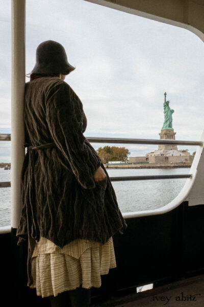 Ellis Duster Coat in Slate Crinkled Velvet; Ellis Frock in Brooklyn Slate Windwopane Wool; Ellis Sash in Uptown Washed Stripe Voile; Ellis Shirt in Apple Washed Crinkled Weave; Liberté Frock in Uptown Washed Stripe Voile.