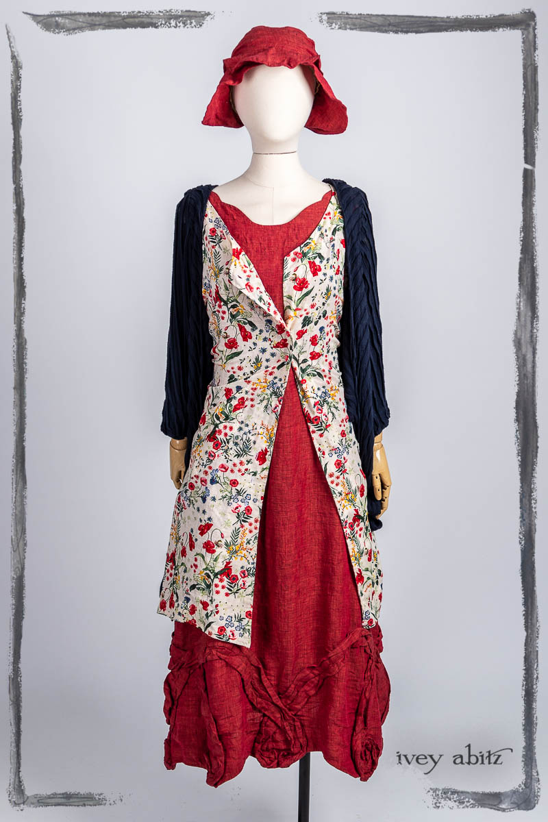 Vallonné Jacket in Bastille Blue Flutter Pleat Knit; Ellis Frock in Poppy Garden Weave; Bartholdi Frock in Poppy Washed Linen; Hapgood Hat in Poppy Washed Linen. Bespoke clothing by Ivey Abitz.
