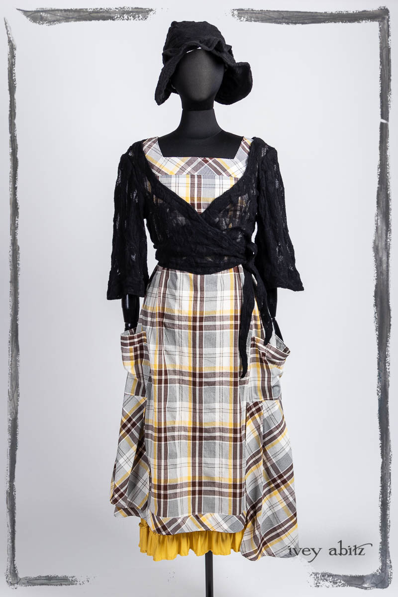 Vallonné Jacket in Noir Embroidered Lace Knit; Meriwether Frock in Clapboard Cottage Washed Plaid; Hapgood Hat in Noir Puckered Knit; Essentielle Frock in Marigold Plant Based Knit. Bespoke clothing by Ivey Abitz.