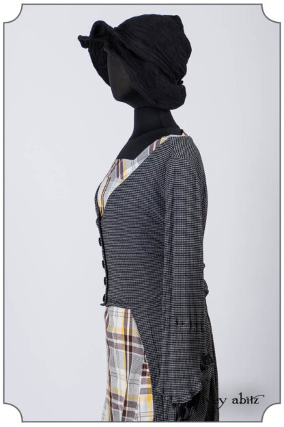 Highbridge Duster Coat in Grey Gardens Stripe and Ribbed Knit; Meriwether Frock in Clapboard Cottage Washed Plaid; Hapgood Hat in Noir Puckered Knit; Essentielle Frock in Marigold Plant Based Knit. Bespoke clothing by Ivey Abitz.