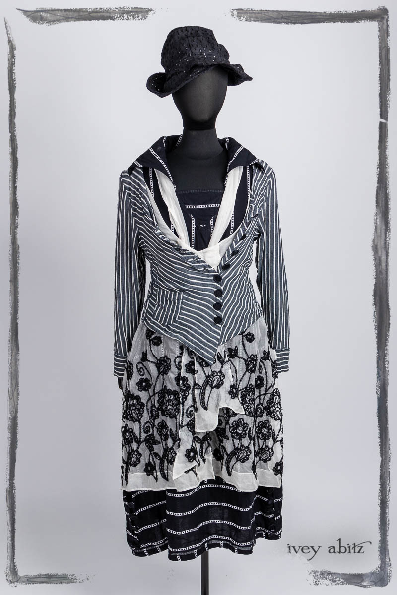 Limited Edition Gilbert Cardigan in Noir and Blanche Stretch Stripe; Ettienne Frock in Noir and Blanche Embroidered Silk Organza, Ettienne Sash in Noir and Blanche Embroidered Silk Organza; Viv Frock in Noir Embroidered Stripe Voile; Hapgood Hat in Noir Circle Embroidered Linen. Bespoke clothing by Ivey Abitz.