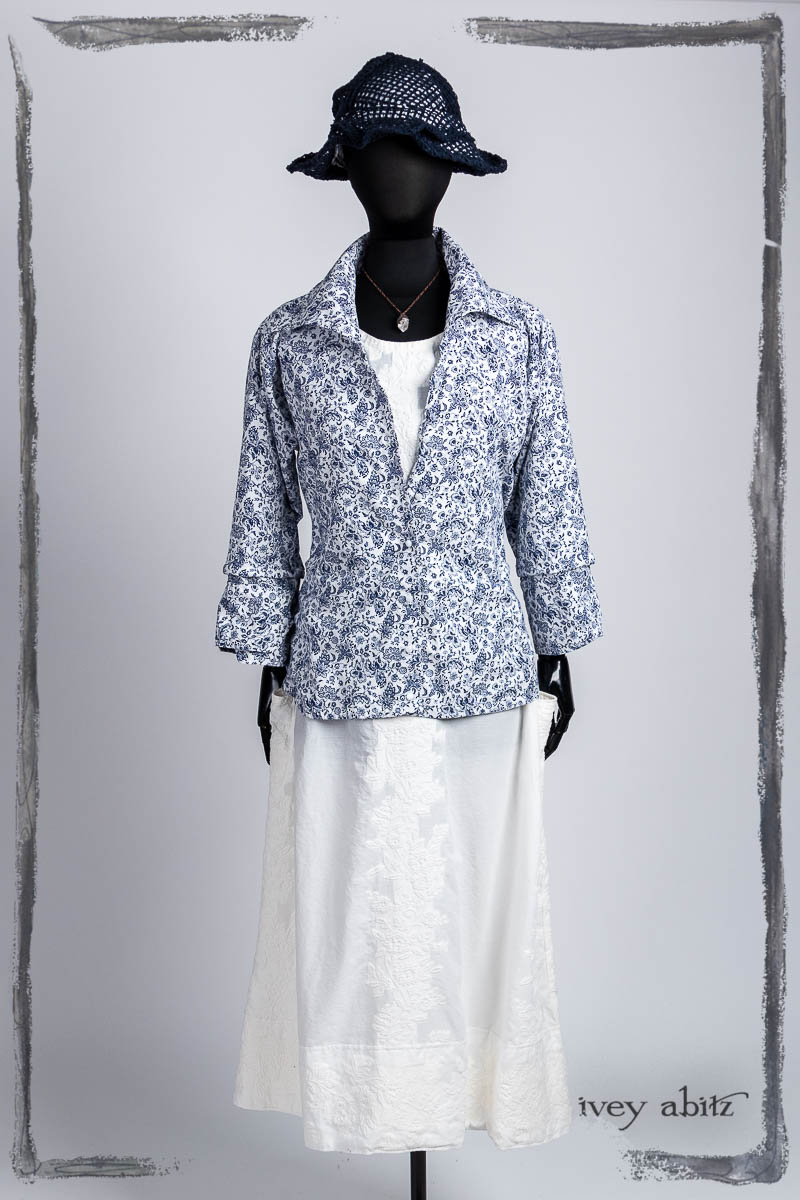 Baedeker Shirt in Bastille Blue Fleur Cotton; Limited Edition Covante Frock in Blanche Embroidered Stripe Voile; Hapgood Hat in Bastille Blue Open Weave Knit; Nouvelle Necklace. Bespoke clothing by Ivey Abitz.