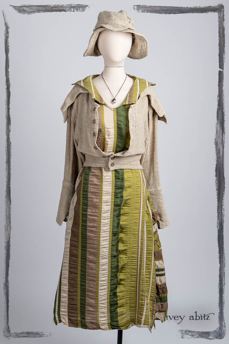 Furtherafield Jacket in Beach Cottage Soft Spun Weave; Limited Edition Etta Frock in Lush Puckered Stripe; Hapgood Hat in Beach Cottage Soft Spun Weave; Nouvelle Necklace. Bespoke clothing by Ivey Abitz.