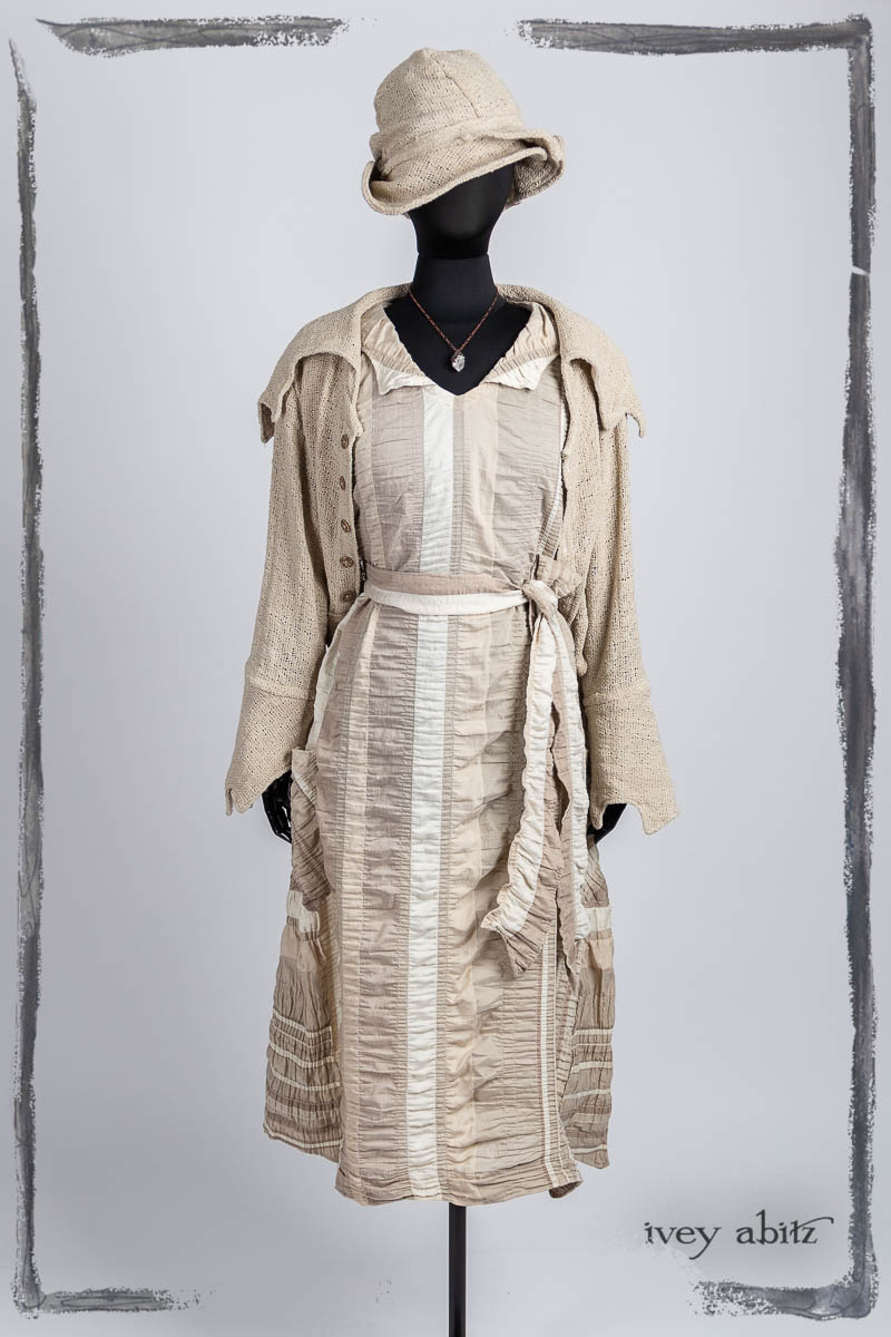 Furtherafield Jacket in Beach Cottage Soft Spun Weave; Limited Edition Etta Frock in Beach Cottage Puckered Stripe; Hapgood Hat in Beach Cottage Soft Spun Weave; Nouvelle Necklace. Bespoke clothing by Ivey Abitz.