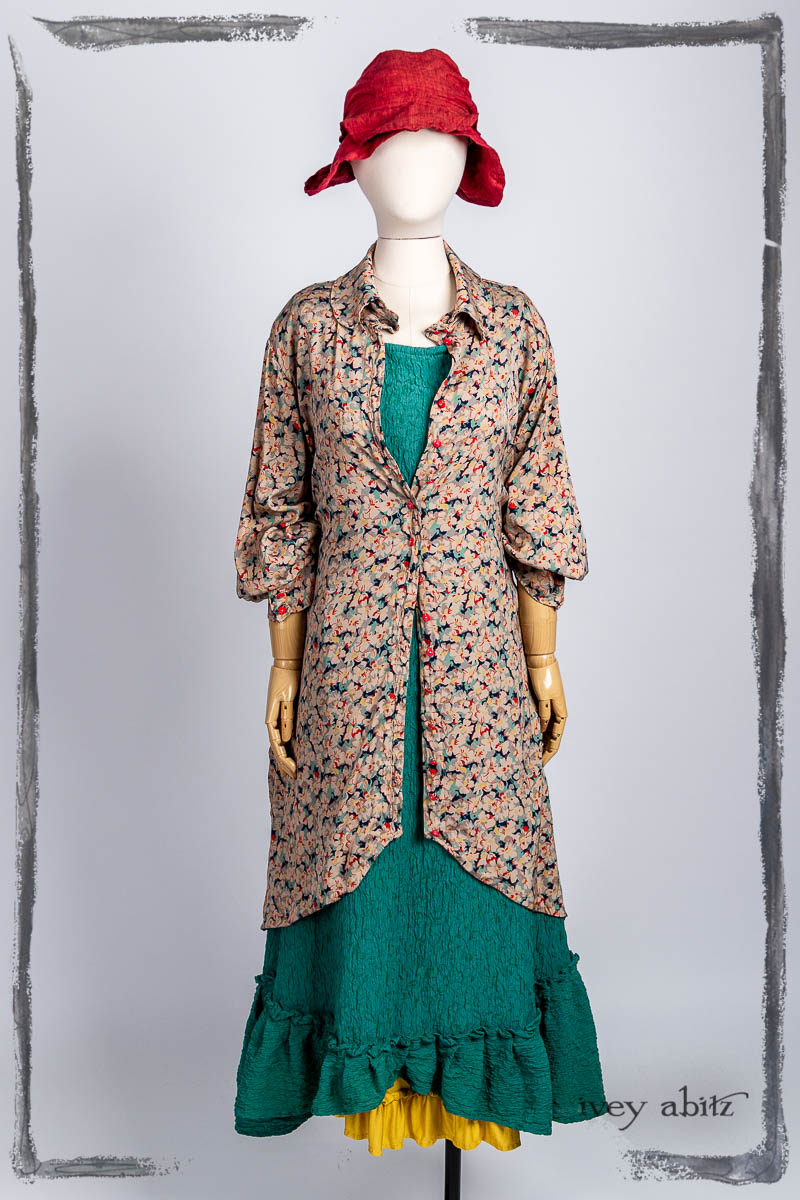 Truitt Shirt Jacket in Veranda Fleur Stretch Silk Charmeuse; Tilbrook Frock in Veranda Puckered Washed Silk; Essentielle Frock in Marigold Plant Based Knit; Hapgood Hat in Poppy Washed Linen. Bespoke clothing by Ivey Abitz.