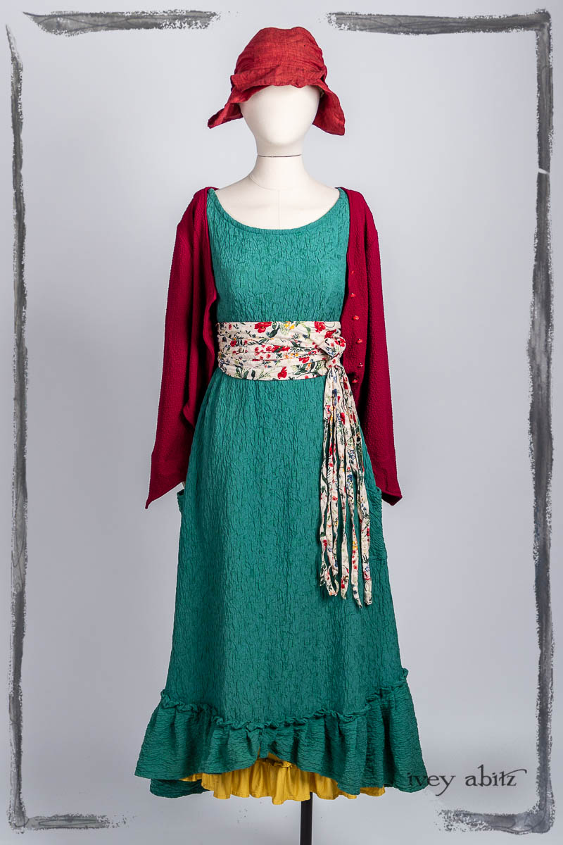 Liberté Jacket in Poppy Puckered Knit; Tilbrook Frock in Veranda Puckered Washed Silk; Porte Cochere Sash in Poppy Garden Weave; Essentielle Frock in Marigold Plant Based Knit; Hapgood Hat in Poppy Washed Linen. Bespoke clothing by Ivey Abitz.