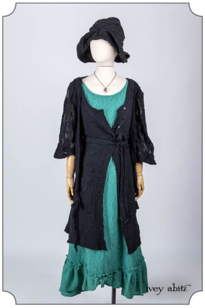Vallonné Jacket in Noir Embroidered Lace Knit; Ellis Frock in Noir Puckered Washed Silk; Tilbrook Frock in Veranda Puckered Washed Silk; Hapgood Hat in Noir Puckered Knit; Nouvelle Necklace. Bespoke clothing by Ivey Abitz.