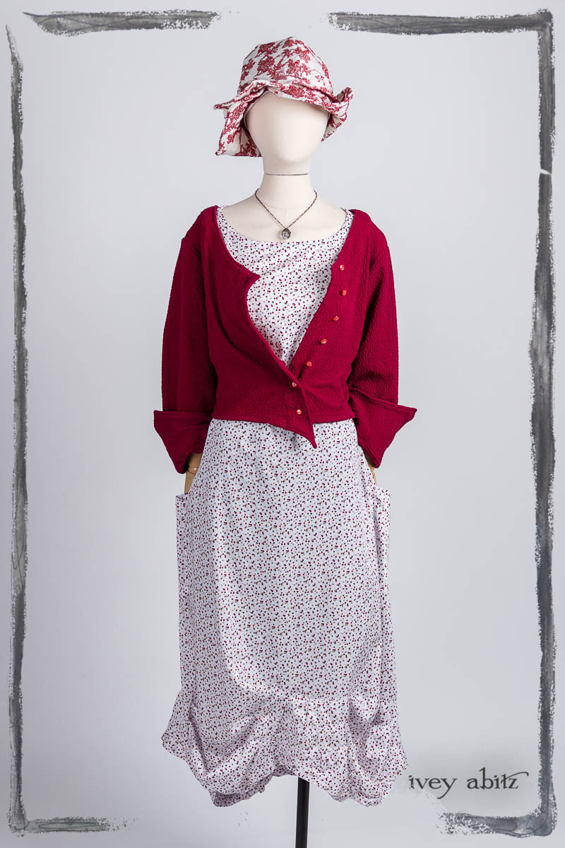 Liberté Jacket in Poppy Puckered Knit; Scattergood Frock in Peony and Poppy Scattered Dot Weave; Hapgood Hat in Poppy Embroidered Hat Weave; Nouvelle Necklace. Bespoke clothing by Ivey Abitz.