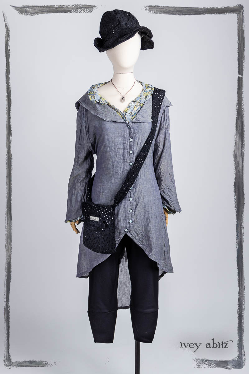 Arthur Hill Duster Coat in Bluebell Cross Weave Washed Voile; Pierrepont Breeches-Leggings in Noir Ponte Knit; Arthur Hill Shirt in Bluebell Floral Silk Chiffon; Voyage Satchel in Noir Circle Embroidered Linen; Hapgood Hat in Noir Circle Embroidered Linen; Nouvelle Necklace. Bespoke clothing by Ivey Abitz.