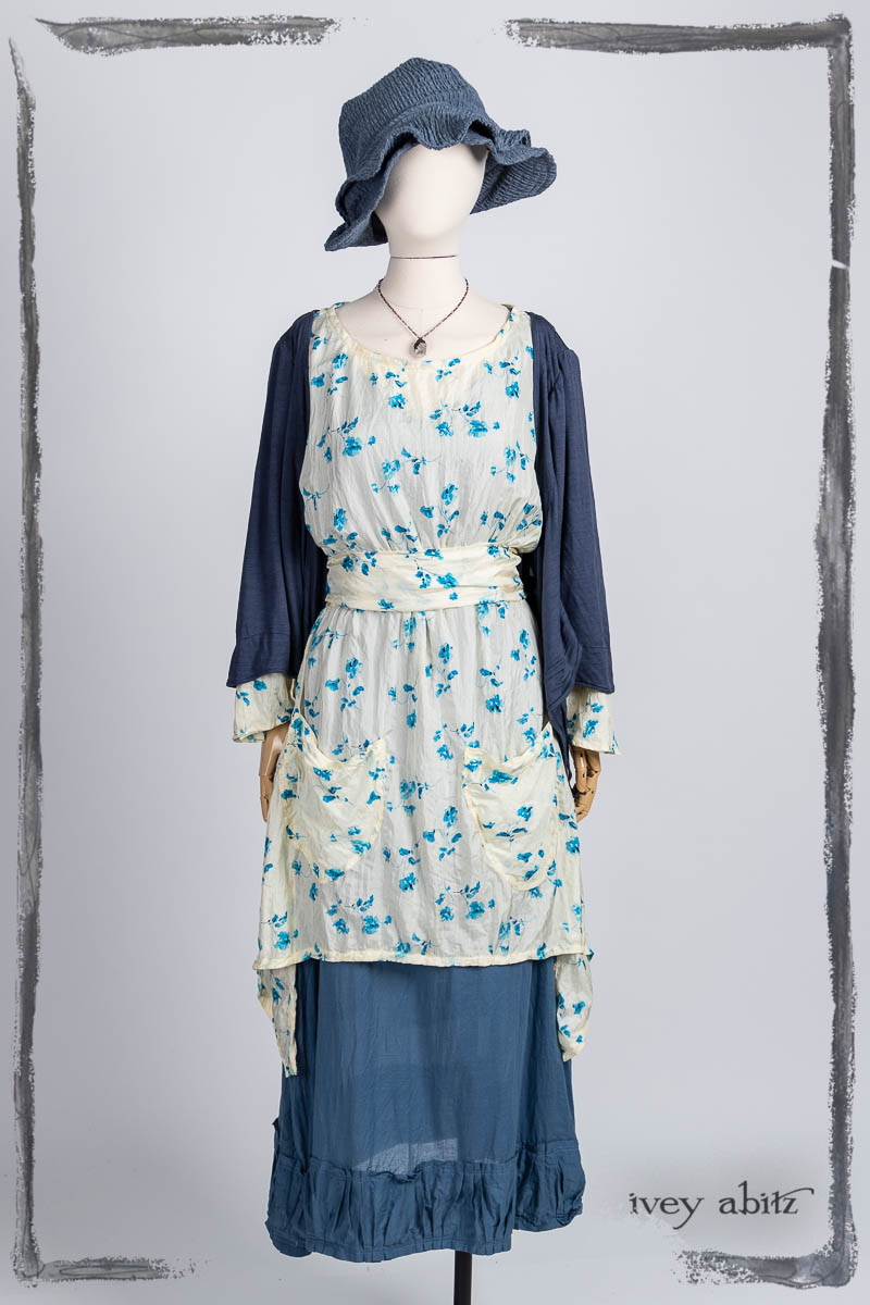 Delphine Dress in Summer Veranda Floral Crushed Silk; Vallonné Jacket in Bluebell Washed Silk Jersey Knit; Gabled Frock in Bastille Blue Washed Batiste; Hapgood Hat in Bluebell Puckered Hat Weave; Nouvelle Necklace. Bespoke clothing by Ivey Abitz.