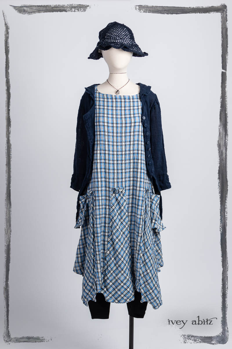 Campanella Shirt Jacket in Bastille Blue Washed Crinkled Weave; Furthafield Frock in Seaside Woven Plaid; Pierrpont Breeches-Leggings in Noir Ponte Knit; Hapgood Hat in Bastille Blue Open Weave Knit; Nouvelle Necklace. Bespoke clothing by Ivey Abitz.