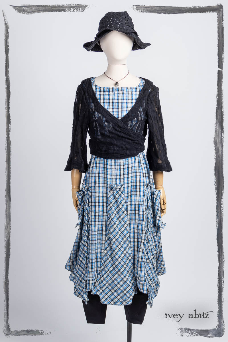 Vallonné Jacket in Noir Embroidered Lace Knit; Furtherafield Frock in Seaside Woven Plaid; Pierrepont Breeches-Leggings in Noir Ponte Knit; Hapgood Hat in Noir Circle Embroidered Linen; Nouvelle Necklace. Bespoke clothing by Ivey Abitz.