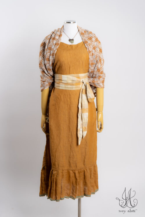 Rosemarie Wrap in Ripe Apricot Embroidered Weave; Rennie Frock in Ripe Apricot Washed Weave; Heirloom Necklace.