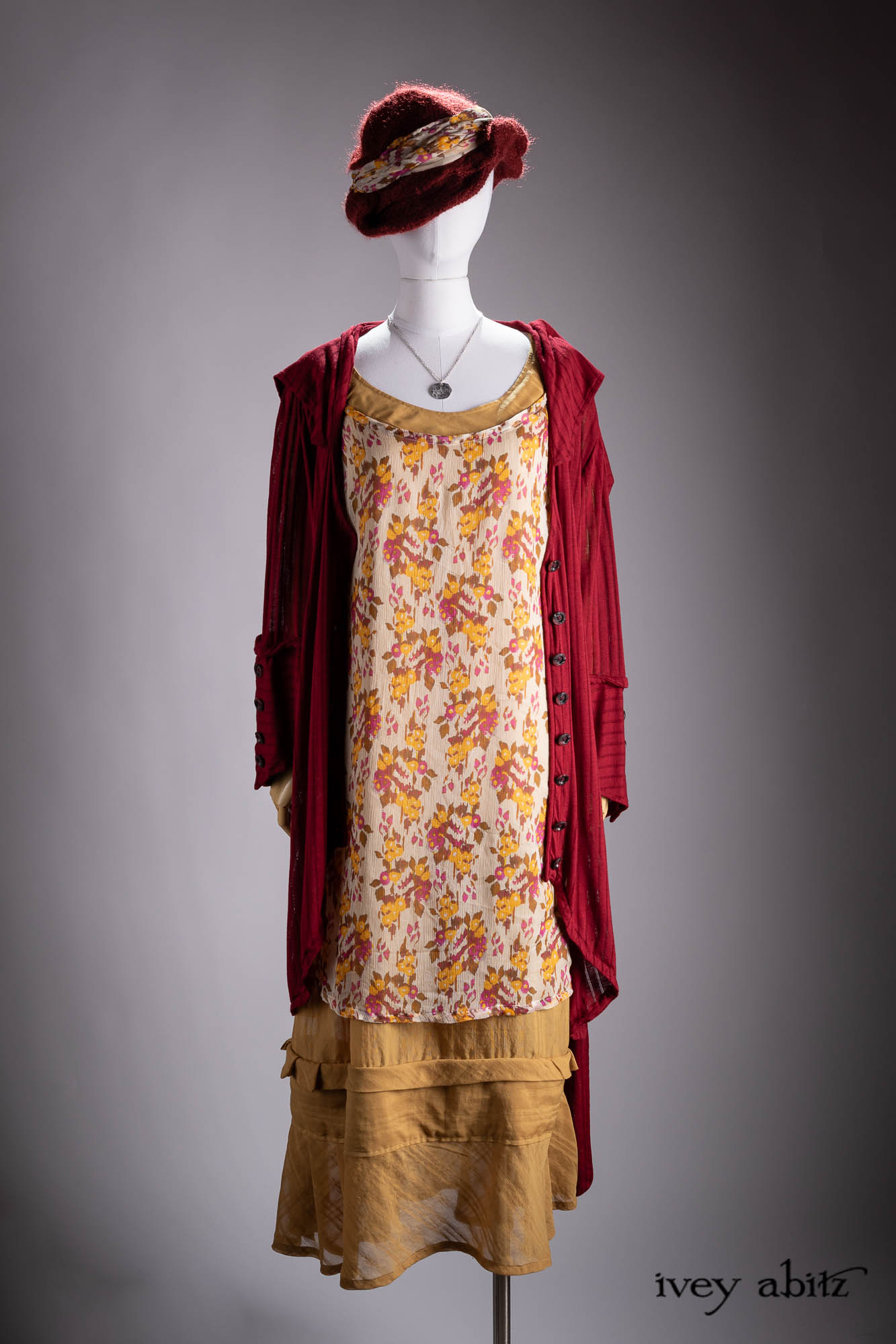 Vanetten Duster Coat in River Fog Ethereal Soft Voile; Liberte Frock in Riverbank Floral Woven Weave; Baedeker Scarf in Crimson Sky Floral Silk Velvet; Cilla Slip Frock in Bark Silky Knit; Hapgood Hat in Bark Washed Woven Hat Weave; Heirloom Necklace.