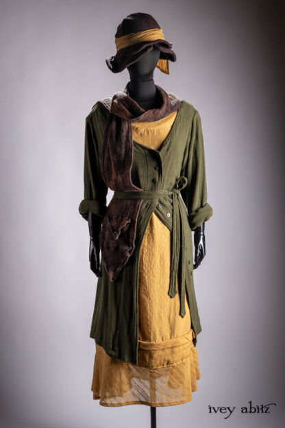 Ellis Duster Coat in Idyllic Green Woven Weave; Hudson Frock in Autumn Leaf Embroidered Stripe Voile; Cilla Slip Frock in Bark Silky Knit; Baedeker Scarf in Bark Mottled Mohair Hat and Scarf Knit; Hapgood Hat in Bark Washed Woven Hat Weave; Fairholme Sash in Autumn Leaf Embroidered Stripe Voile.