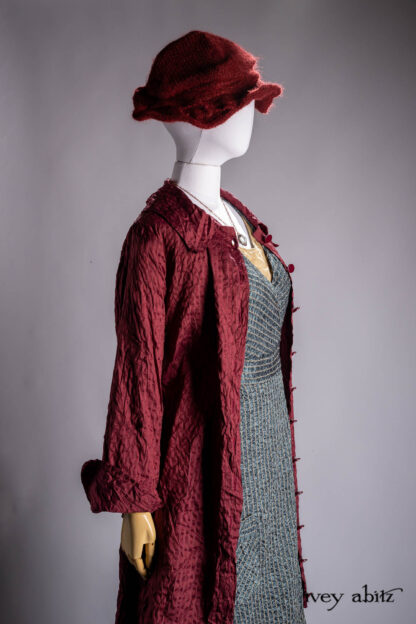 Chittister Duster Coat in Crimson Sky Washed Stripe Silk; Chomley Frock in Valley Sky and Natural Embroidered Stripe Washed Silk; Liberte Frock in Riverbank Floral Woven Weave; Crimson Sky Mohair Hat and Scarf Knit; Nouvelle Necklace.