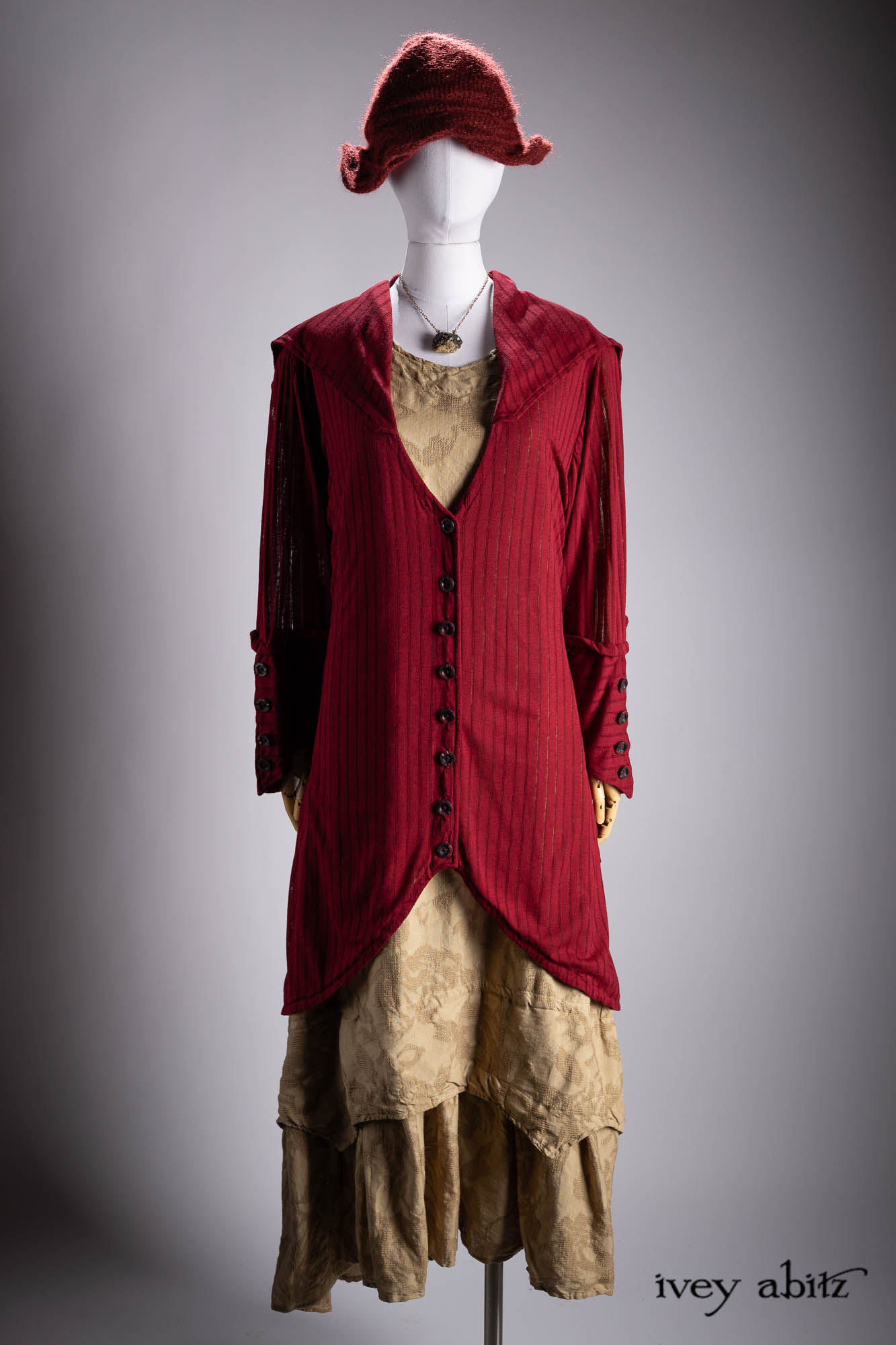 Henrietta Duster Coat in Crimson Sky Pointelle Stripe Knit; Liberte Frock in Riverbank Floral Woven Weave; Hapgood Hat in Crimson Sky Mohair Hat and Scarf Knit; Heirloom Necklace.