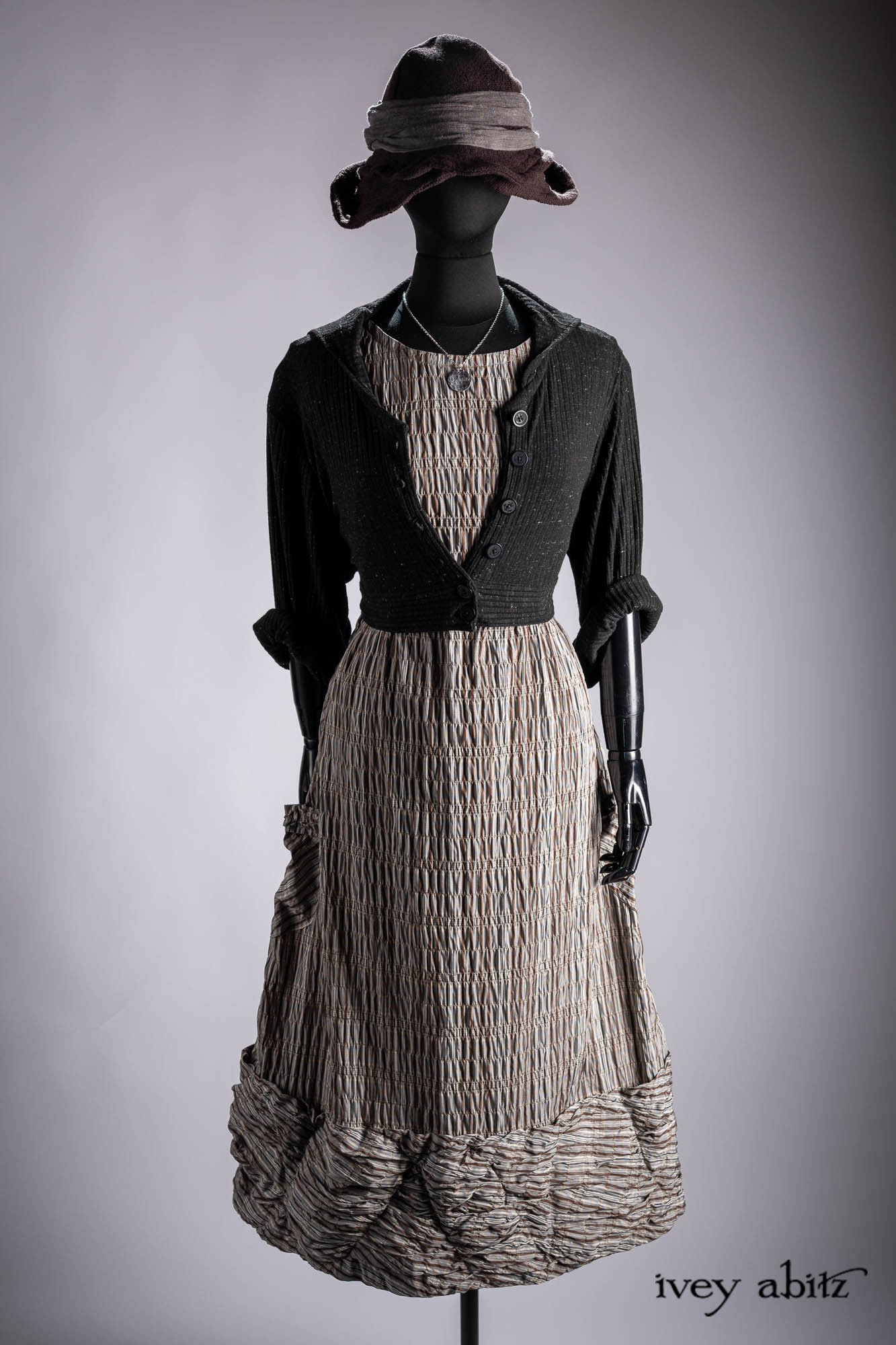 Ellis Duster Coat in Idyllic Green Woven Weave; Pierrepont Shirt in Crimson Three-Leaf Silk; Liberte Frock in Riverbank Floral Woven Weave; Cilla Slip Frock in Bark Silky Knit; Hapgood Hat in Bark Washed Woven Hat Weave; Nouvelle Necklace.