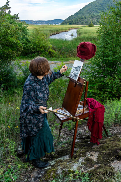 Cynthia Ivey Abitz painting Iona Island on location. Truitt Shirt Jacket in Valley Sky Three Leaf Silk Fairholme Frock in Valley Sky Softest Charmeuse Henrietta Duster Coat in Crimson Sky Pointelle Stripe Knit Hapgood Hat in Crimson Sky Mohair Hat and Scarf Knit