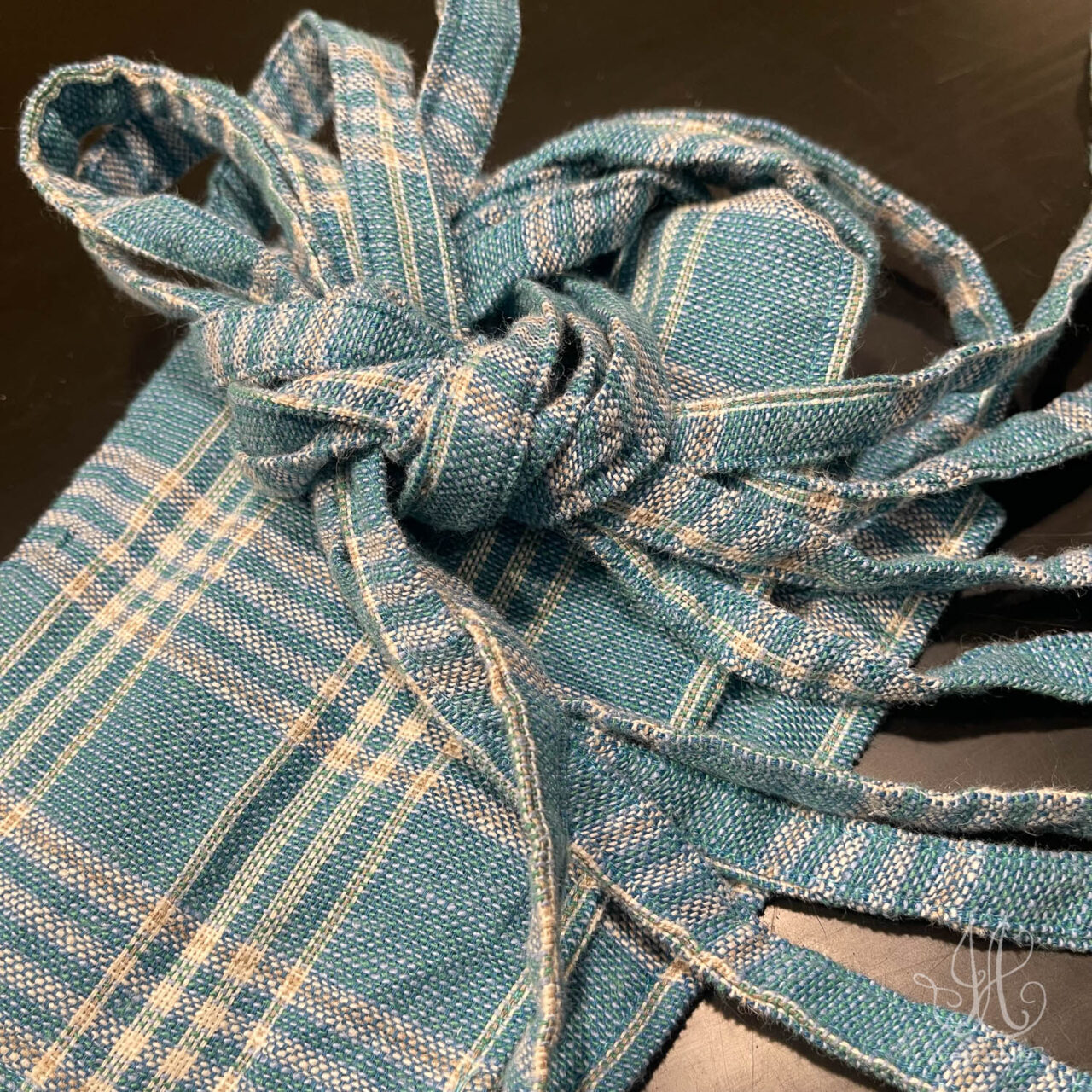 Detail of a sash before placing it lovingly and carefully in an Ivey Abitz presentation box.