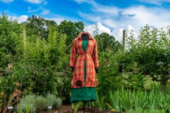 Gabled Duster Coat in Sunnyside Washed Plaid; Campanella Frock in Gracious Green Washed Crinkled Linen; Idyll Brooch in Rose Garden Silk Weaves. Ivey Abitz at Boscobel House and Gardens