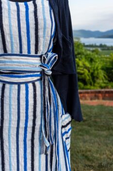 Harrison Frock in Hudson Blue Embroidered Stripe Voile; Porte Cochere Sash in Hudson Blue Embroidered Stripe Voile; Cilla Slip Frock in Peony Soft Ribbed Knit; Crest Jacket in Hudson Blue Soft Ribbed Knit; Soutache Brooch in Black Weaves. Ivey Abitz at Boscobel House and Gardens
