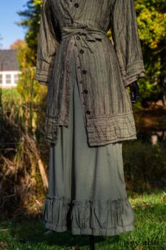 Gabled Duster Coat in Peace and Civility Stripe Linen; Gabled Shirt Jacket in Civility Washed Linen; Gabled Trousers in Civility Washed Stretch Weave; Clotaire Sash in Civility Garden Row Silk Chiffon. Location: Near the bridge and entrance to Stone Cottage and Val-Kill Cottage, the home of Eleanor Roosevelt. Eleanor Roosevelt National Historic Site, Hyde Park, New York.