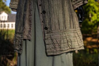 Gabled Duster Coat in Peace and Civility Stripe Linen; Gabled Shirt Jacket in Civility Washed Linen; Gabled Trousers in Civility Washed Stretch Weave; Clotaire Sash in Civility Garden Row Silk Chiffon. Location: Near the bridge and entrance to Stone Cottage and Val-Kill Cottage, the home of Eleanor Roosevelt. Eleanor Roosevelt National Historic Site, Hyde Park, New York.