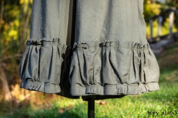 Gabled Duster Coat in Peace and Civility Stripe Linen; Gabled Shirt Jacket in Civility Washed Linen; Gabled Trousers in Civility Washed Stretch Weave; Clotaire Sash in Civility Garden Row Silk Chiffon. Location: Near the bridge and entrance to Stone Cottage and Val-Kill Cottage, the home of Eleanor Roosevelt. Eleanor Roosevelt National Historic Site, Hyde Park, New York.