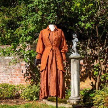 Truitt Shirt Jacket in Independence Embroidered Washed Silk; Eleanora Frock in Independence Washed Linen. Location: Inside the walled garden at the Eleanor Roosevelt National Historic Site. Val-Kill Cottage, Hyde Park, New York.