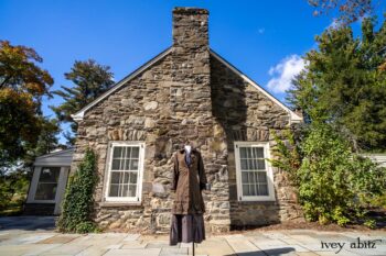 Hudson Duster Coat in Peace Soft Pinstripe Cotton; Hudson Frock in Civility Soft Check Twill; Porte Cochere Sash in Civility Floral Stretch Weave. Location: East profile of Stone Cottage. Eleanor Roosevelt National Historic Site. Val-Kill, Hyde Park, New York.
