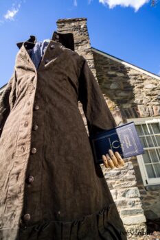 Hudson Duster Coat in Peace Soft Pinstripe Cotton; Hudson Frock in Civility Soft Check Twill; Porte Cochere Sash in Civility Floral Stretch Weave. Location: East profile of Stone Cottage. Eleanor Roosevelt National Historic Site. Val-Kill, Hyde Park, New York.