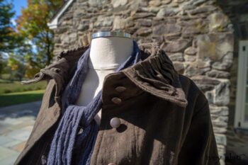 Hudson Duster Coat in Peace Soft Pinstripe Cotton; Hudson Frock in Civility Soft Check Twill; Porte Cochere Sash in Civility Floral Stretch Weave. Location: East profile of Stone Cottage. Eleanor Roosevelt National Historic Site. Val-Kill, Hyde Park, New York.