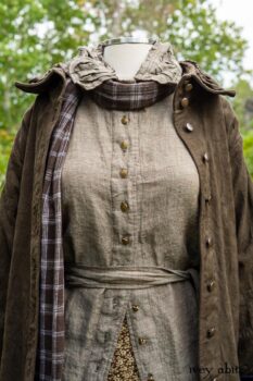 Gabled Duster Coat in Civility Floral Stretch Weave; Gabled Shirt Jacket in Civility Washed Linen; Baedeker Scarf in Dignity Soft Plaid Flannel; Gabled Skirt in Dignity Floral Cotton Twill. Location: Eleanor's garden and west profile of Stone Cottage. Eleanor Roosevelt National Historic Site. Val-Kill, Hyde Park, New York.