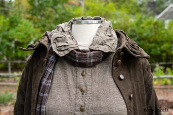 Gabled Duster Coat in Civility Floral Stretch Weave; Gabled Shirt Jacket in Civility Washed Linen; Baedeker Scarf in Dignity Soft Plaid Flannel; Gabled Skirt in Dignity Floral Cotton Twill. Location: Eleanor's garden and west profile of Stone Cottage. Eleanor Roosevelt National Historic Site. Val-Kill, Hyde Park, New York.