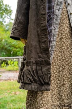 Gabled Duster Coat in Civility Floral Stretch Weave; Gabled Shirt Jacket in Civility Washed Linen; Baedeker Scarf in Dignity Soft Plaid Flannel; Gabled Skirt in Dignity Floral Cotton Twill. Location: Eleanor's garden and west profile of Stone Cottage. Eleanor Roosevelt National Historic Site. Val-Kill, Hyde Park, New York.
