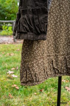 Gabled Duster Coat in Civility Floral Stretch Weave; Gabled Shirt Jacket in Civility Washed Linen; Baedeker Scarf in Dignity Soft Plaid Flannel; Gabled Skirt in Dignity Floral Cotton Twill. Location: Eleanor's garden and west profile of Stone Cottage. Eleanor Roosevelt National Historic Site. Val-Kill, Hyde Park, New York.