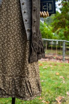 Gabled Duster Coat in Civility Floral Stretch Weave; Gabled Shirt Jacket in Civility Washed Linen; Baedeker Scarf in Dignity Soft Plaid Flannel; Gabled Skirt in Dignity Floral Cotton Twill. Location: Eleanor's garden and west profile of Stone Cottage. Eleanor Roosevelt National Historic Site. Val-Kill, Hyde Park, New York.