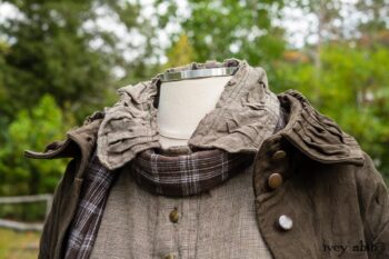 Gabled Duster Coat in Civility Floral Stretch Weave; Gabled Shirt Jacket in Civility Washed Linen; Baedeker Scarf in Dignity Soft Plaid Flannel; Gabled Skirt in Dignity Floral Cotton Twill. Location: Eleanor's garden and west profile of Stone Cottage. Eleanor Roosevelt National Historic Site. Val-Kill, Hyde Park, New York.