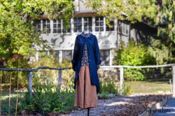 Chittister Duster Coat in Liberty Pin Tuck Twill; Truitt Shirt in Independence Floral and Vine Weave; Montague Trousers in Independence Stripe Cotton. Location: Inside the front garden at the Eleanor Roosevelt National Historic Site. Val-Kill, Hyde Park, New York.