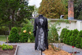 Scattergood Duster Coat in Unity Washed Linen; Scattergood Frock in Unity Floral Linen. Location: Inside Eleanor's rose garden and behind the old forge used to create pewter for Val-Kill Industries. When Val-Kill closed, Eleanor turned the factory into her home and the forge into a playhouse for her grandchildren. Eleanor Roosevelt National Historic Site. Hyde Park, New York.