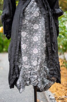 Scattergood Duster Coat in Unity Washed Linen; Scattergood Frock in Unity Floral Linen. Location: Inside Eleanor's rose garden and behind the old forge used to create pewter for Val-Kill Industries. When Val-Kill closed, Eleanor turned the factory into her home and the forge into a playhouse for her grandchildren. Eleanor Roosevelt National Historic Site. Hyde Park, New York.