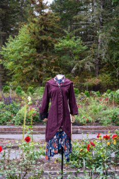 Arthur Hill Duster Coat in Honour Floral Stretch Weave; Arthur Hill Shirt in Liberty Soft Ribbed Knit; Fitz Frock in Independence Cottage Garden Weave; Blanchefleur Sash in Independence Cottage Garden Weave. Location: Inside Eleanor's flower garden. Our Independence Cottage Garden Weave was inspired by it. Eleanor Roosevelt National Historic Site. Val-Kill, Hyde Park, New York.